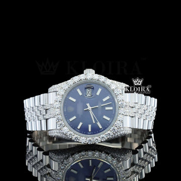 Iced Out Rolex watch with blue dial and diamond-studded bezel, showcasing luxury and elegance in 14K gold.