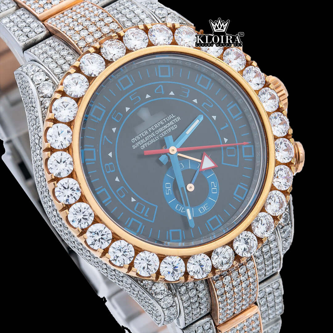 Luxury women's watch with a blue dial and diamond accents, featuring a sparkling gold and silver bracelet.