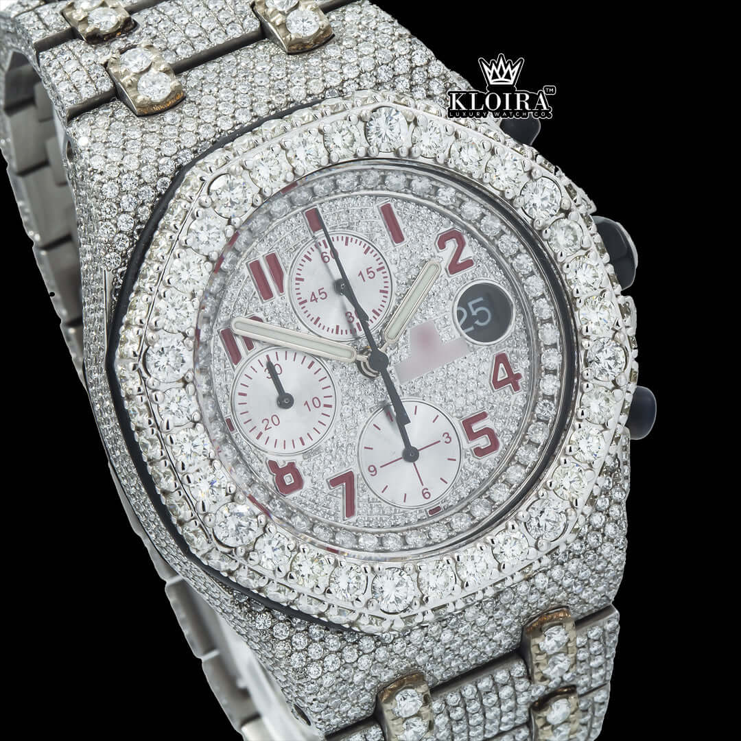 Iced out watch with red numerals and moissanite diamonds, featuring a 42mm case and 14K gold detailing.