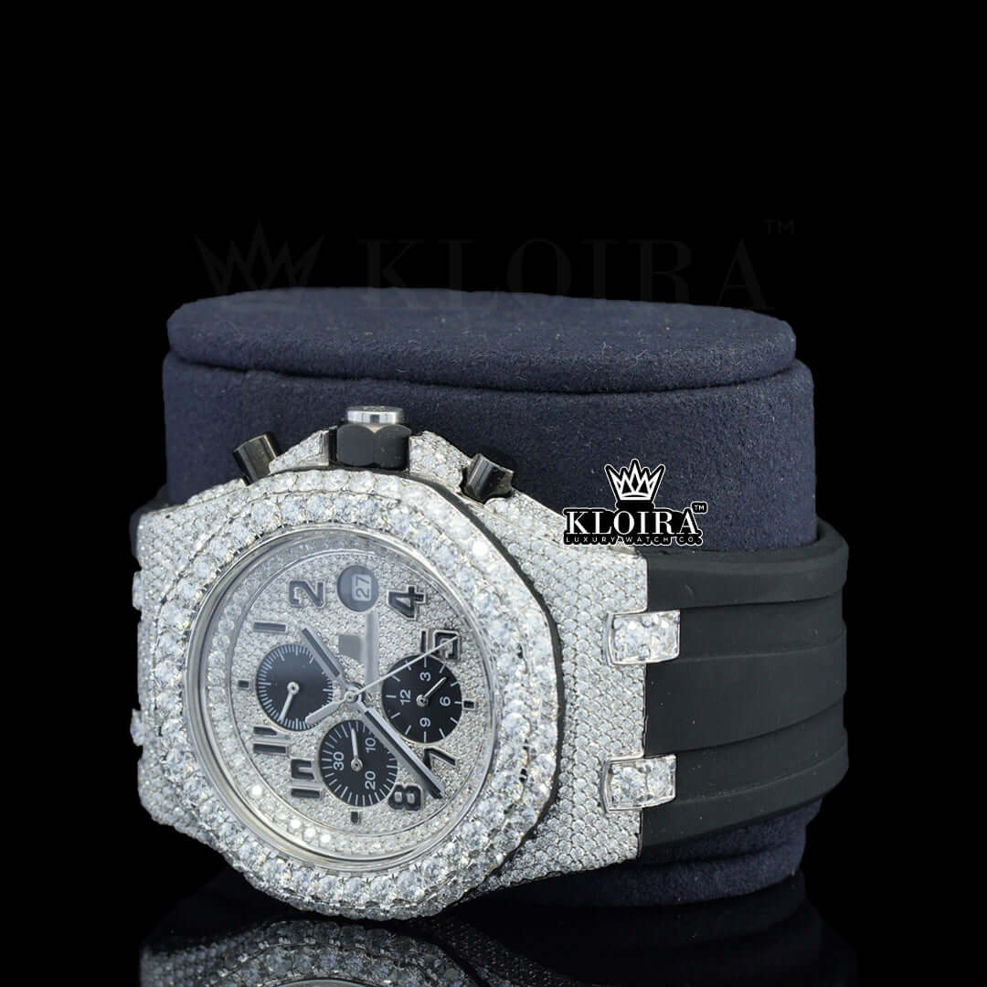 Fully iced out silver dial watch with moissanite diamonds on a black rubber strap, featuring bold black hands and chronograph dials.