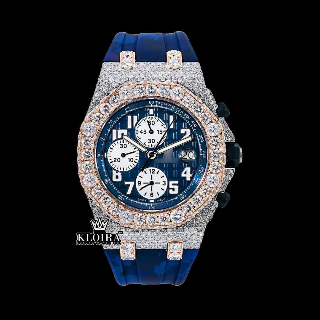 Blue dial rose gold moissanite diamond watch with rubber strap and chronograph functions.
