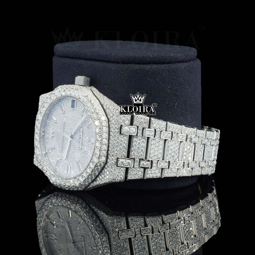 Fully iced out silver watch with sparkling stones and a textured dial, showcasing elegance and luxury.