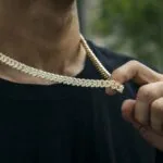 10mm Round Moissanite Cuban Link Chain Regalia in 14K Yellow Gold Closeup Neck