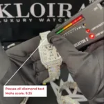 Hand testing a diamond watch with a selector, showing it passes the diamond test with a Mohs scale rating of 9.25.