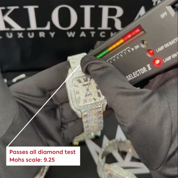Hand testing a diamond watch with a selector, showing it passes the diamond test with a Mohs scale rating of 9.25.