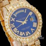 Gold Tone Blue Roman Dial Day Date Display Iced Out Moissanite Watch Close Up Dial View